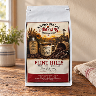 Flint Hills dark roast whole bean coffee, 12 oz bag on a wooden table