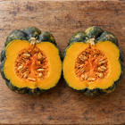 Yuxi Jiang Bing Gua squash - two cut halves on a board showing orange flesh and seeds - Chinese heirloom moschata