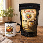 French Roast ground coffee, 8 oz bag with Autumn Prairie mug on a wooden table